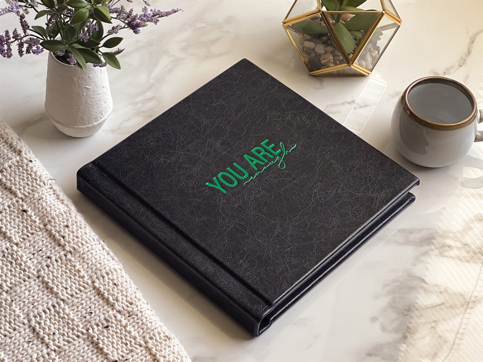 Black leather boudoir album stamped You Are Enough in emerald foil